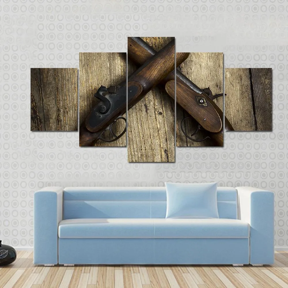 Two Vintage Pistols On Wooden Table Canvas Wall Art