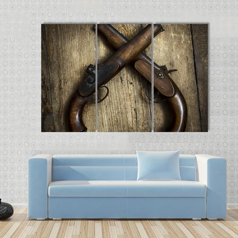 Two Vintage Pistols On Wooden Table Canvas Wall Art